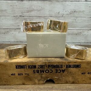 Balos, Hong kong Set of four gold tone, brass, ring napkin holders.